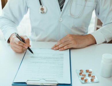 Doctor hand holding pen writing patient history list on note pad