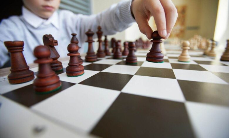 Boy making chess move