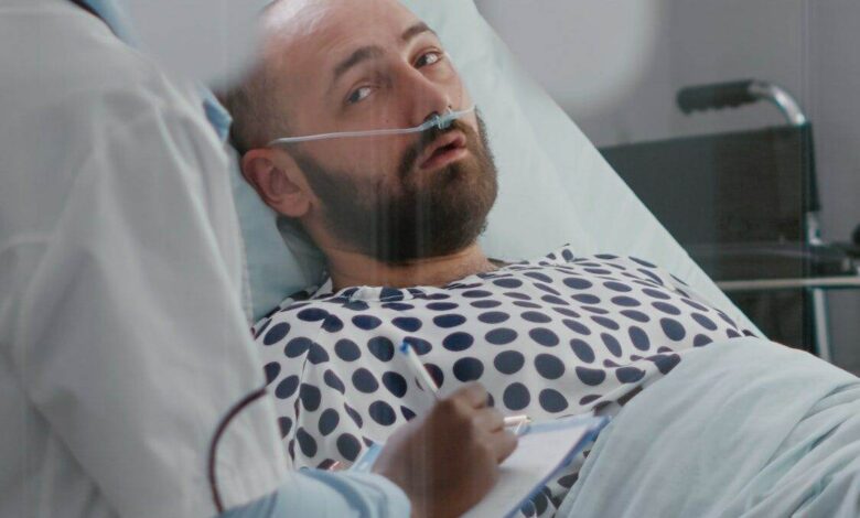 Afro american doctor checking sick man monitoring sickness symptom