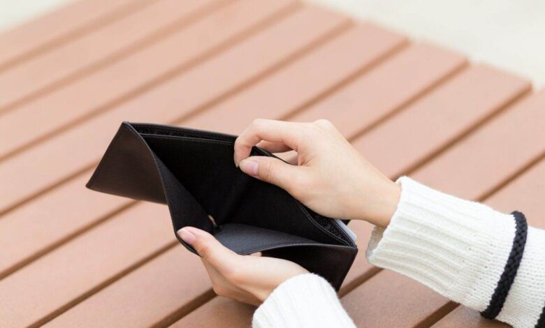 Woman holding an empty wallet