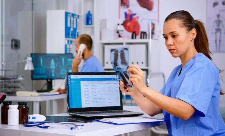 Medical doctor nurse holding and analysing radiography
