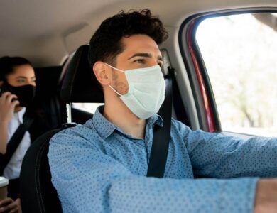 Taxi driver with passenger at back seat.