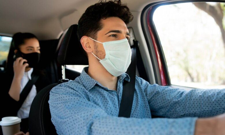 Taxi driver with passenger at back seat.