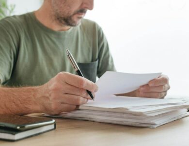 Telecommuter reading project paper document in home office