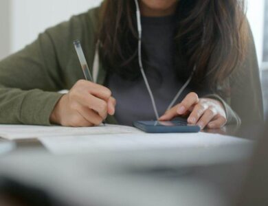 Woman do revision with cellphone at home