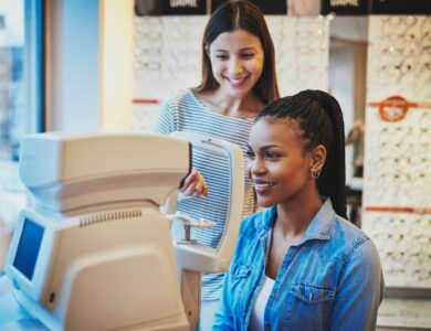 Beautiful young black woman waits to get eye exam