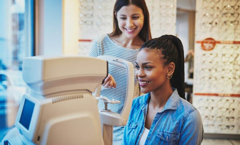 Beautiful young black woman waits to get eye exam