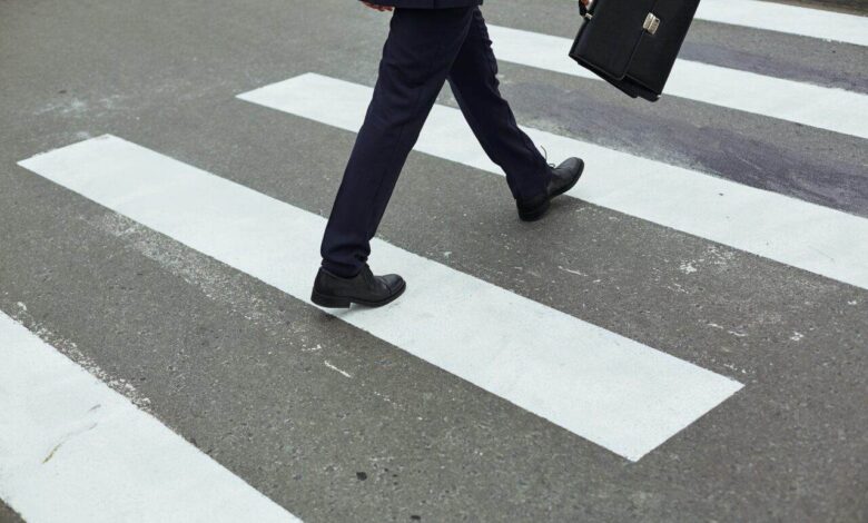 Businessman crossing road