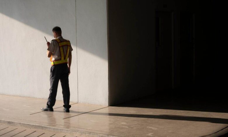 Security guard using walkie talkie while working in underground of parking garage