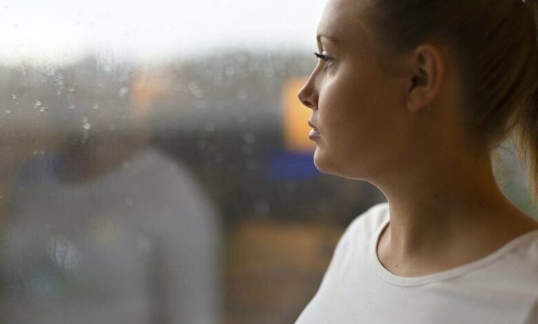 Thoughtful woman looking out the window