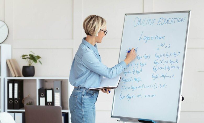 Female university tutor solving complicated math sums during online lesson, explaining logarithms on